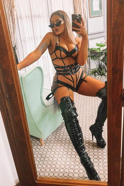 lingerie waitress in very revealing pvc outfit with thigh high stiletto boots in sydney's maroubra area